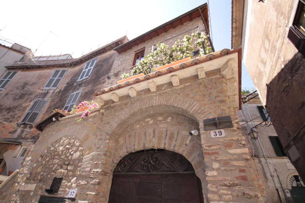 蒂沃利Torre Sant'Antonio的一座石头建筑,上面有鲜花拱门