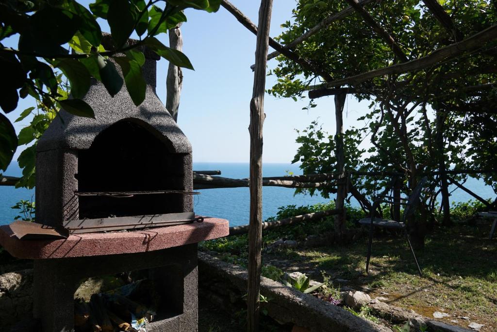 a bird house with the ocean in the background at Bella Baia Relais in Maiori