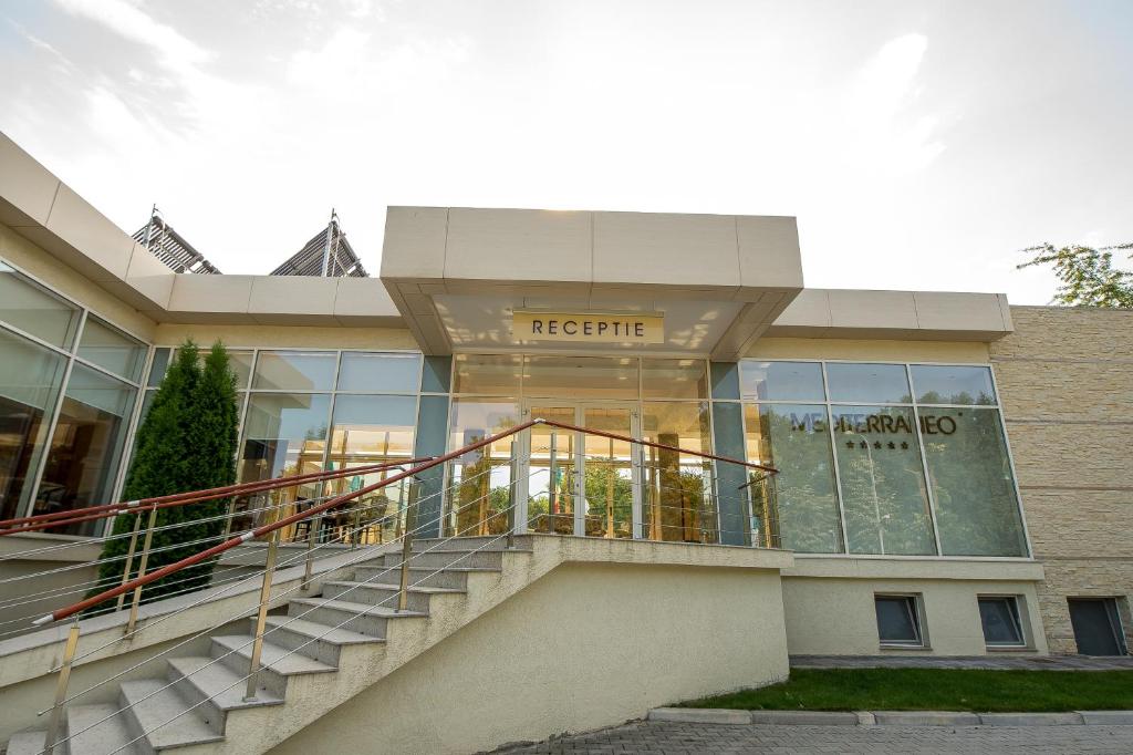 a large building with stairs in front of it at Club de Vacanta Mediterraneo in Neptun