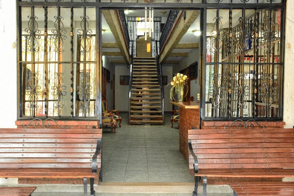 a building with two benches and a staircase in the background at Hotel el Lago 2 in Pereira