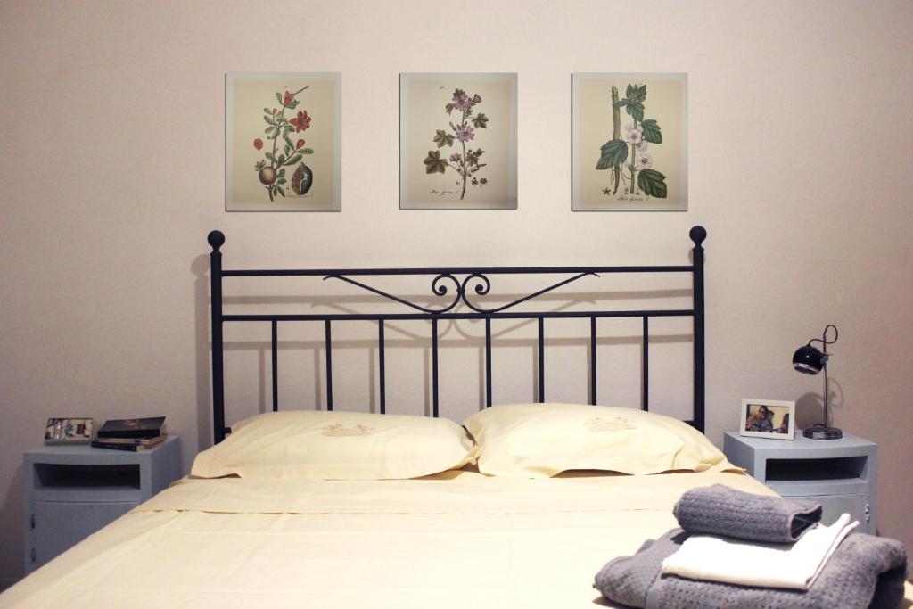 a bedroom with a bed with four pictures on the wall at La Casetta Ferrara B&B in Ferrara