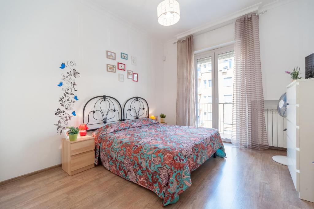 a bedroom with a bed with a colorful bedspread at Vatican Stemar Apartment in Rome