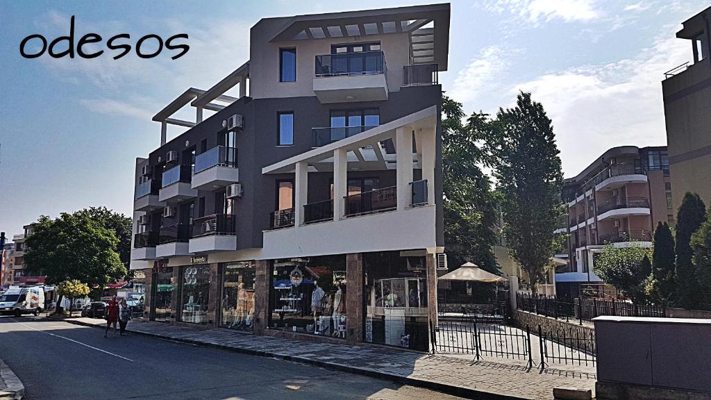 a tall building on the side of a street at Guesthouse Odesos in Sozopol