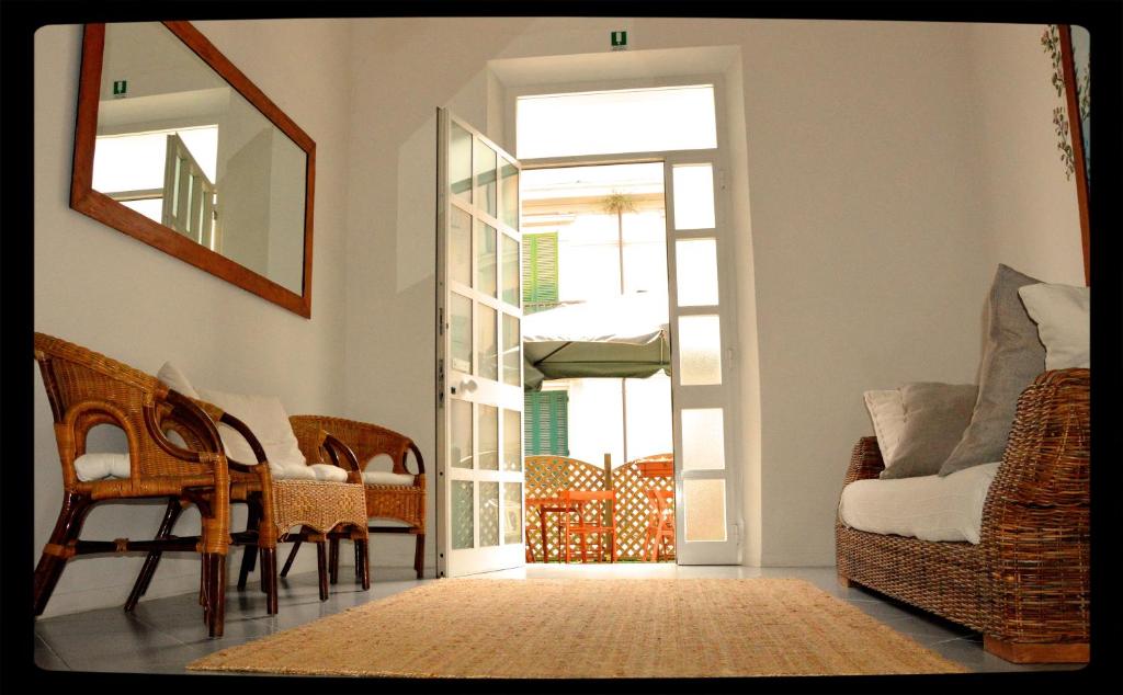a living room with a door and a table and chairs at Hotel Belvedere in Viareggio