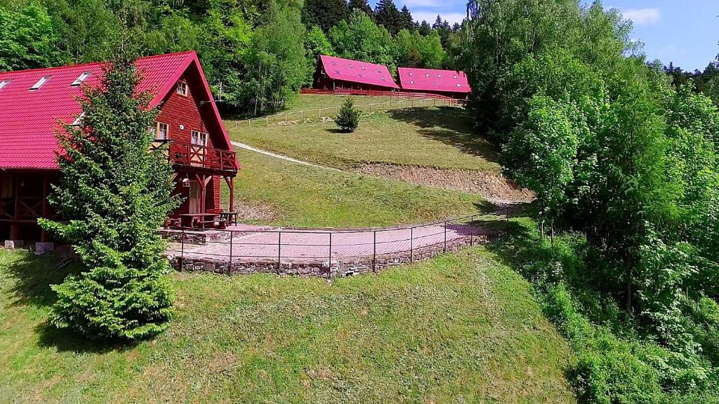 an aerial view of a farm with a red barn at Domki na Górce in Wierchomla Mała