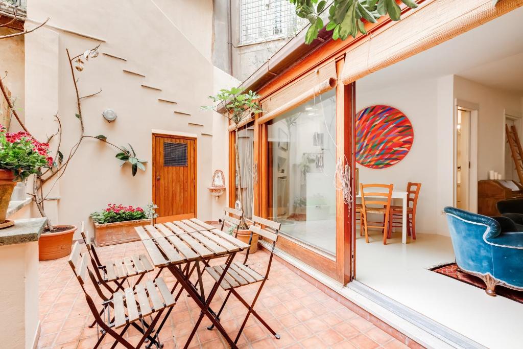a patio with a wooden table and chairs at Al Portico 39 apartment with terrace in Rome