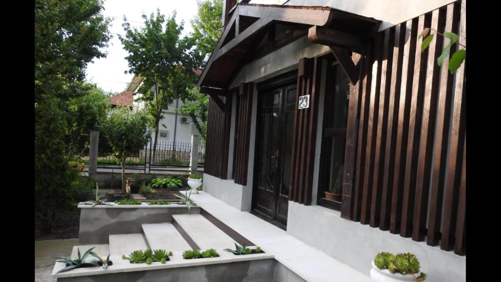 a porch of a house with some plants on it at Vila Hera in Eforie Sud