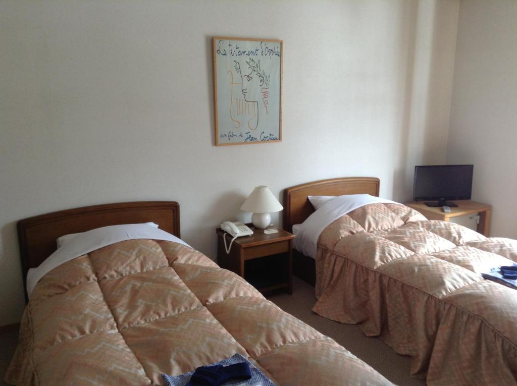Postel nebo postele na pokoji v ubytování Hakuba Alpine Hotel