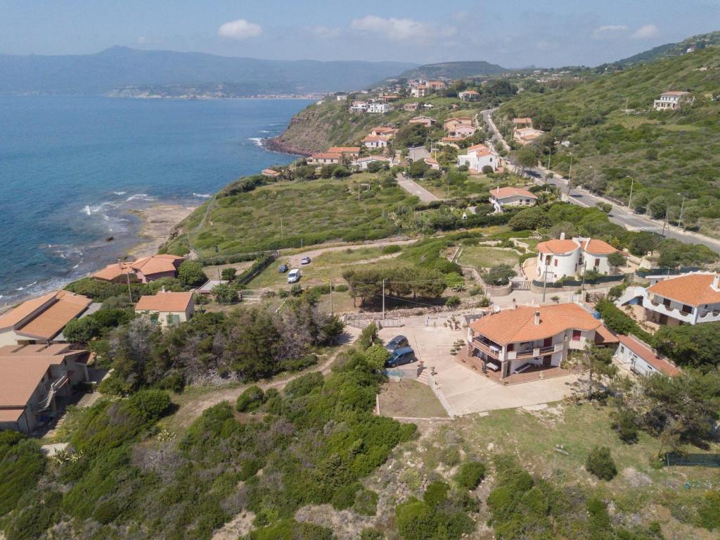 una vista aérea de una casa en una colina junto al océano en Profumo di Mare en Magomadas