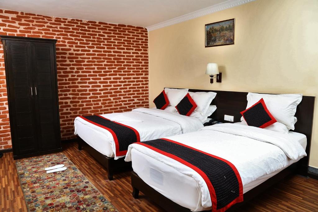 Postel nebo postele na pokoji v ubytování Taleju Boutique Hotel