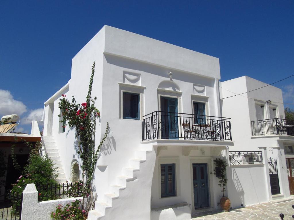 a white building with stairs and balconies on it at Magnificent traditional house in the centre of Naxos in Khalkíon