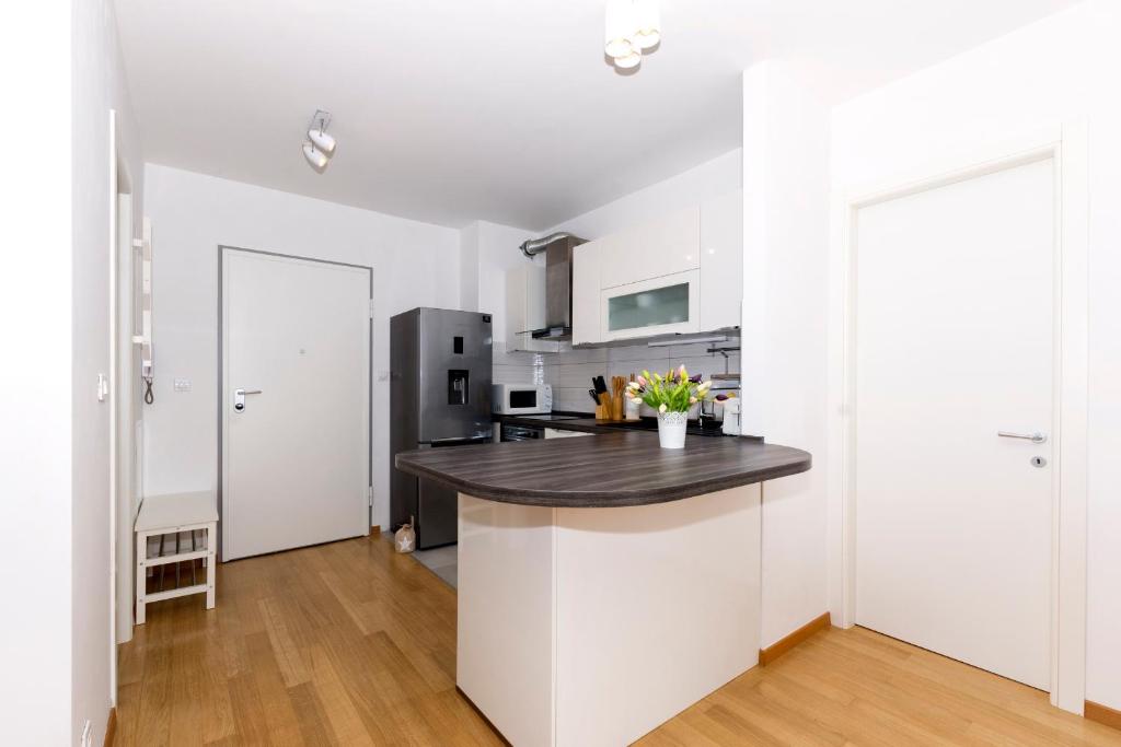 a kitchen with white walls and a black counter top at Cvit Jadrana in Split