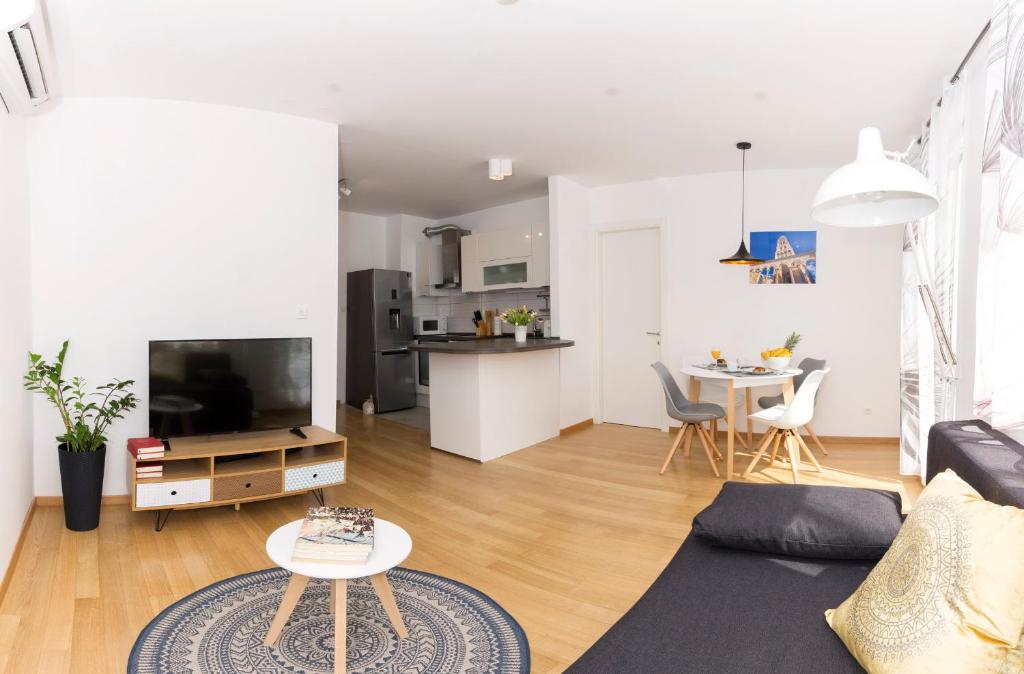 a living room with a couch and a tv at Cvit Jadrana in Split