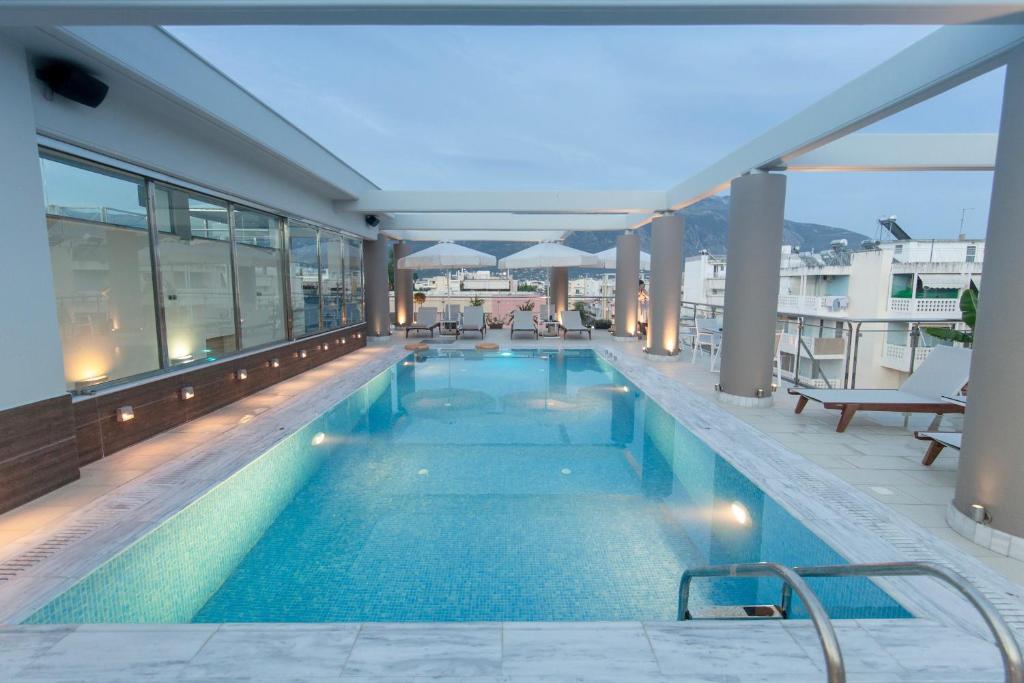 a swimming pool on the roof of a building at Comfy Boutique Hotel in Kalamata