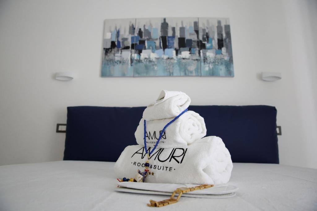 Postel nebo postele na pokoji v ubytování Amuri Room&Suite