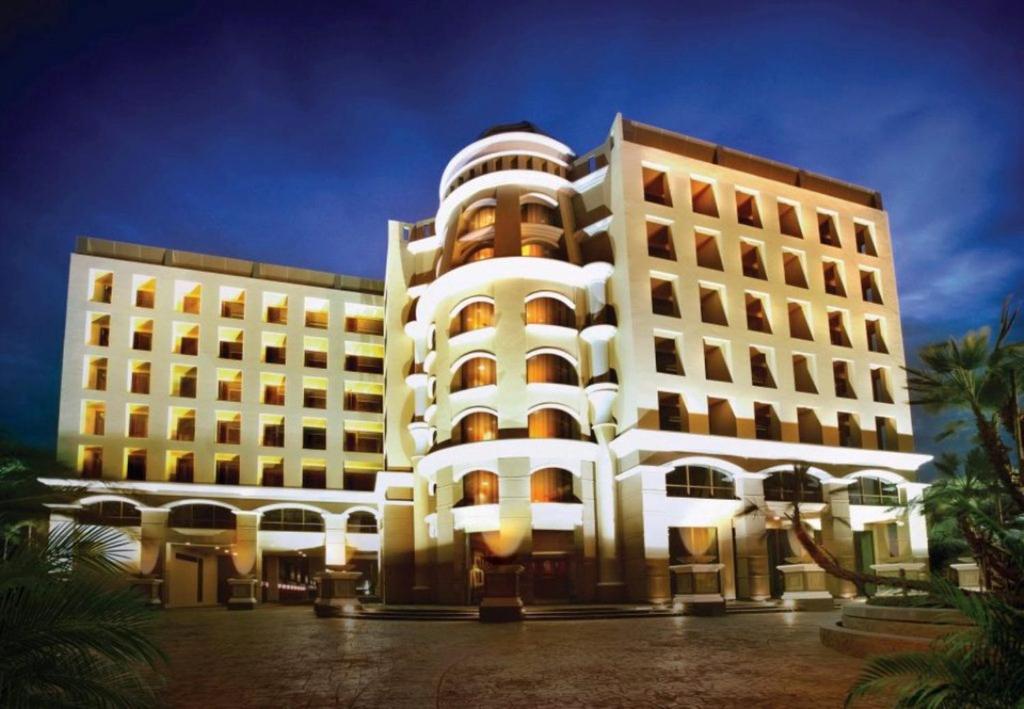 a large white building with lights in front of it at Maleewana Hotel & Resort in Ban Bang Muang