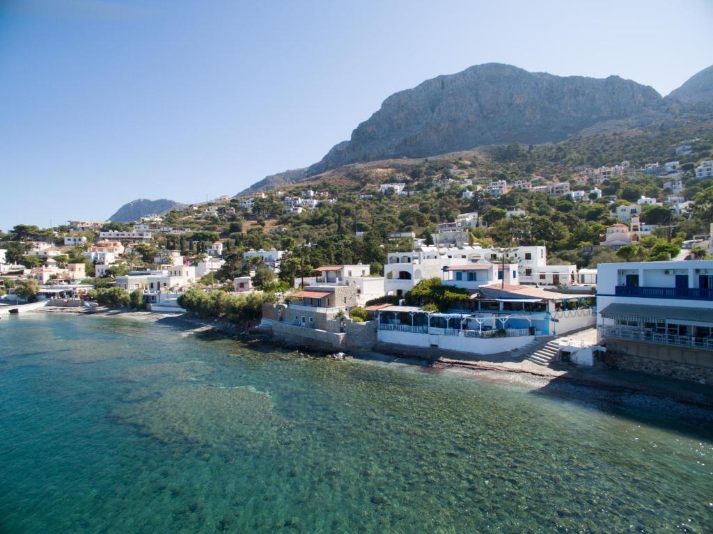 an aerial view of a town next to the water at Avra Studios in Myrties