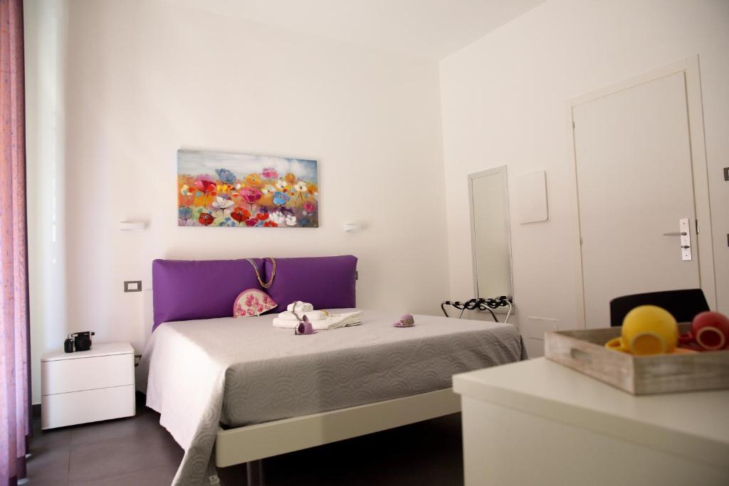Postel nebo postele na pokoji v ubytování Amuri Room&Suite