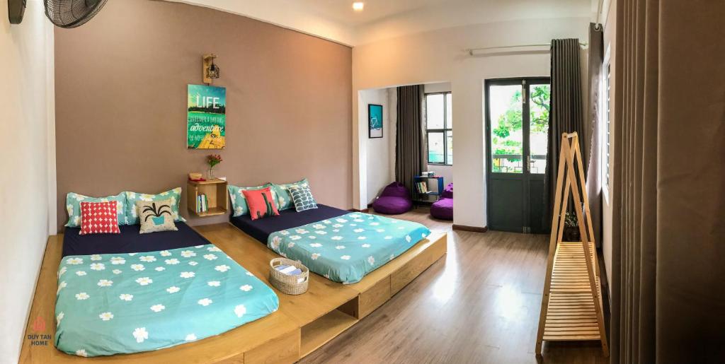 a room with two beds in a room at Duy Tan Home in Quy Nhon