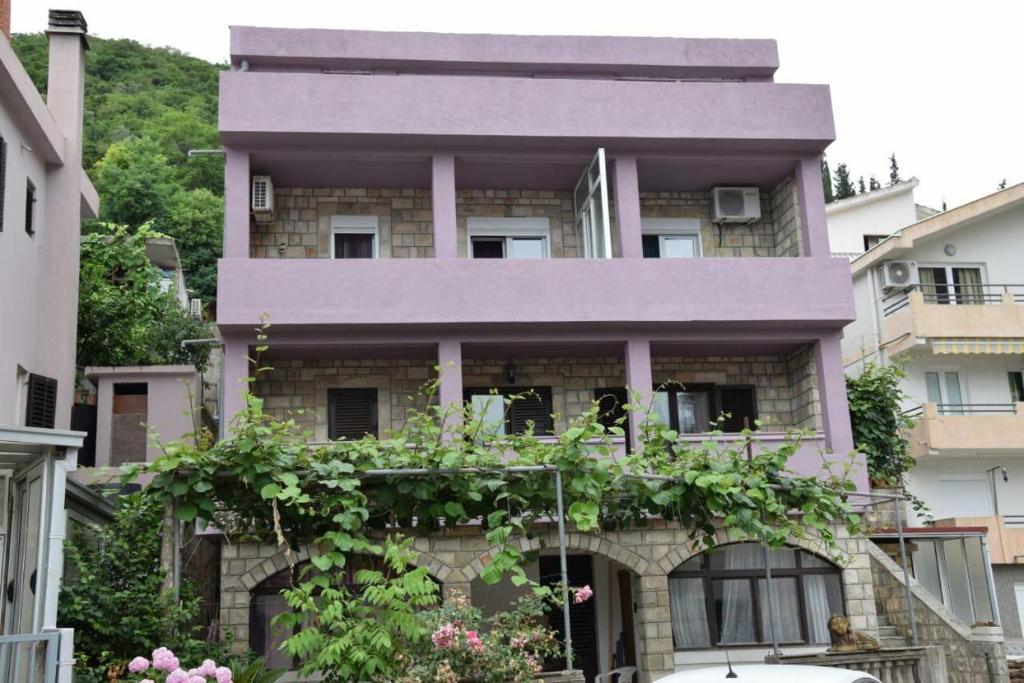 a building with plants on the front of it at Apartman Bećir in Budva