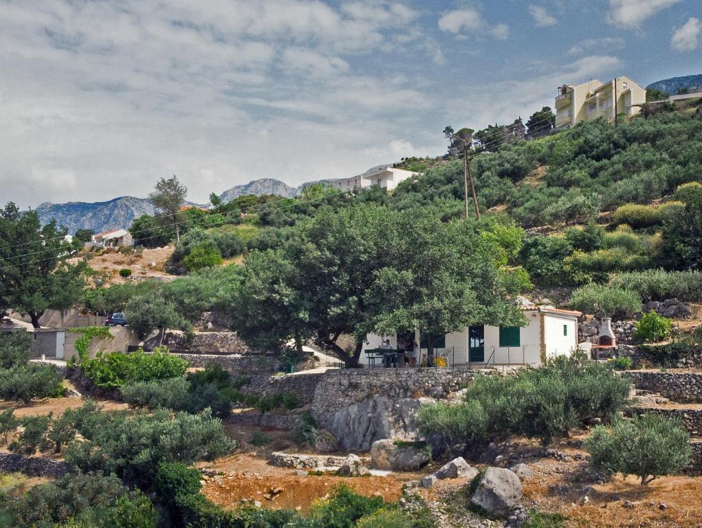 a small village on a hill with trees and bushes at Villa " Davorka" in Podgora