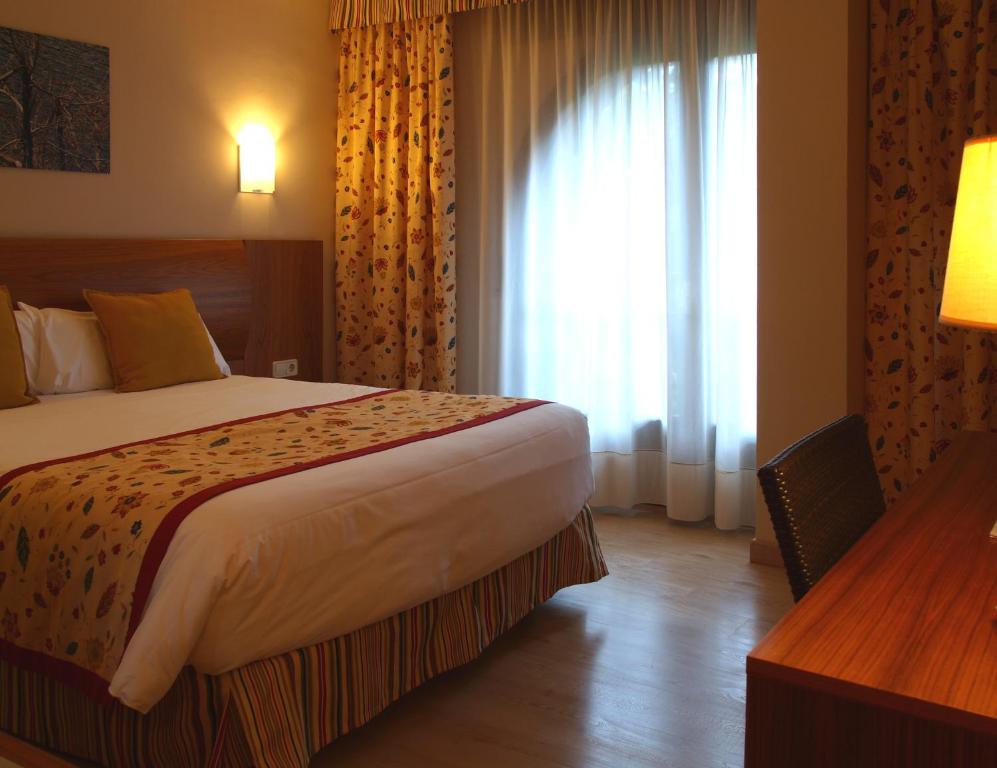 Voodi või voodid majutusasutuse Hotel Guillem & Spa toas