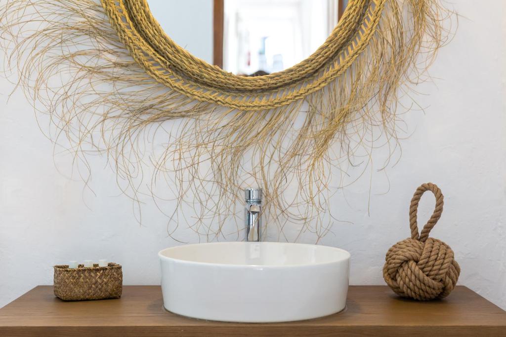 a bathroom with a sink and a mirror at Hostal La Torre Ibiza Cap Negret in San Antonio