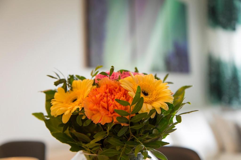 a bouquet of flowers in a vase on a table at Tuomas´ luxurious suites, Nouka in Rovaniemi