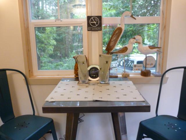a table in a room with two chairs and a window at Magnolia Petal in Ganges