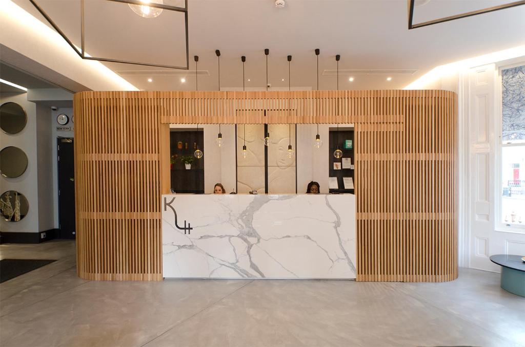 a dressing room with a marble counter in a room at K Hotel Kensington in London
