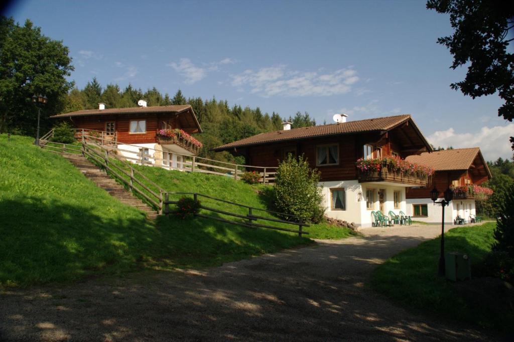 a couple of houses on a hill with a driveway at Blockhaus-Ferienpark in Eisenschmitt