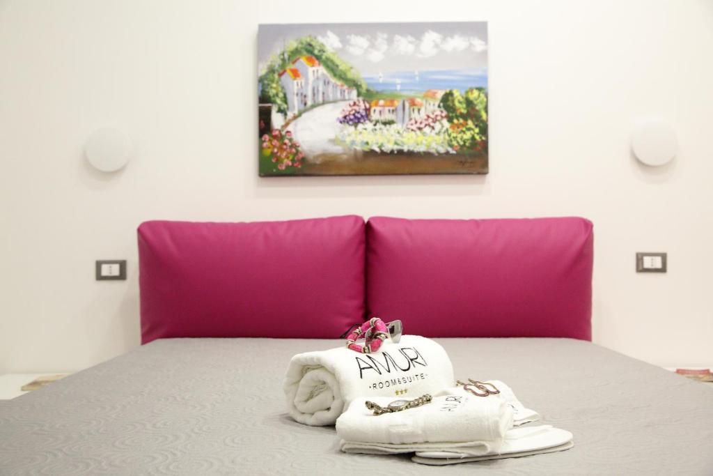 Postel nebo postele na pokoji v ubytování Amuri Room&Suite