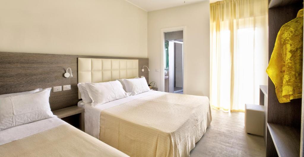 Postel nebo postele na pokoji v ubytování Hotel Clara