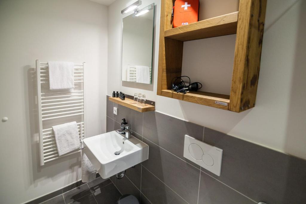 a bathroom with a sink and a mirror at Staycity Aparthotels Dresden City Centre in Dresden