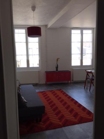 a living room with a couch and a rug at residence brainoise 2 in Braine