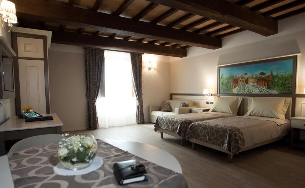 a bedroom with a bed and a table in a room at Tenuta d'Ausilio in Vairano Patenora