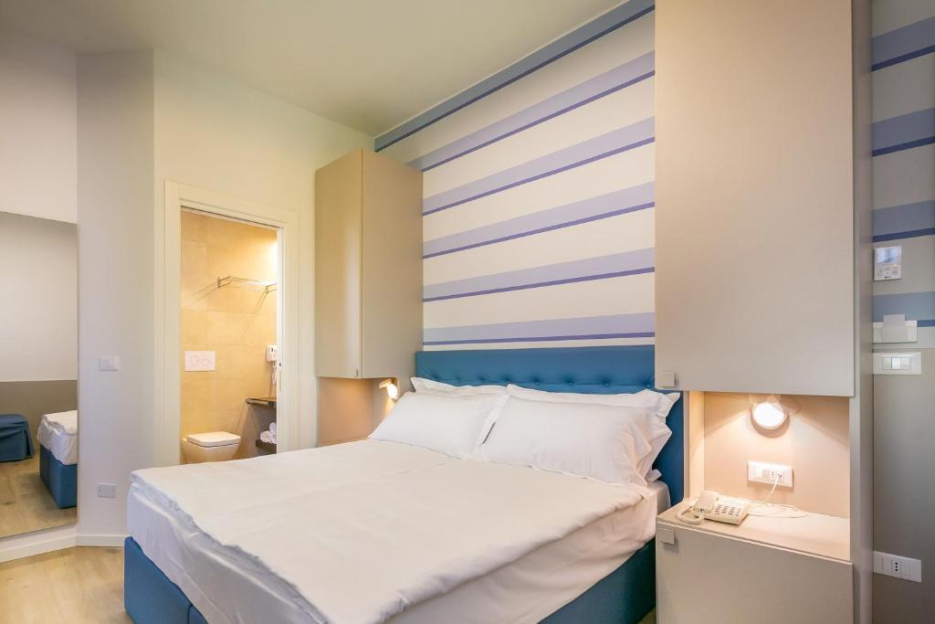 Postel nebo postele na pokoji v ubytování Hotel Le Lampare
