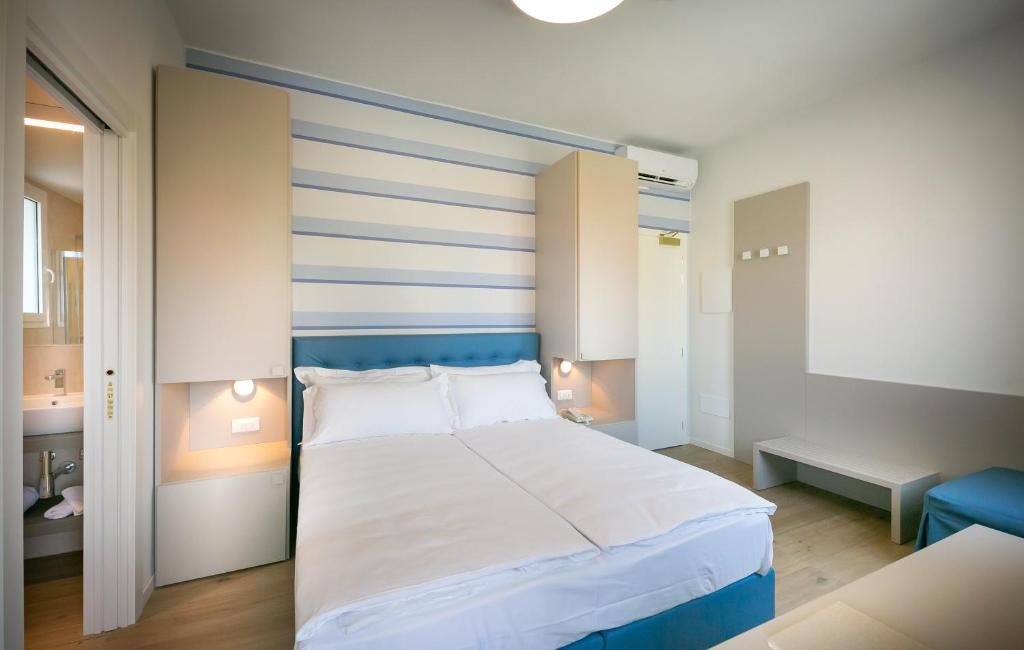 Postel nebo postele na pokoji v ubytování Hotel Le Lampare