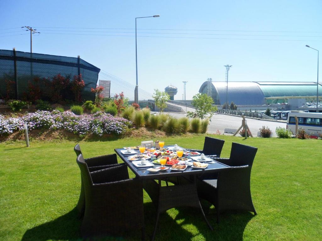 a table with food on it in a field at Orty Airport Hotel in Izmir