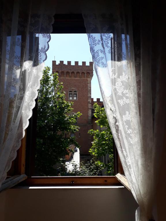 a window with a view of a castle at Torre rossa in Bolgheri