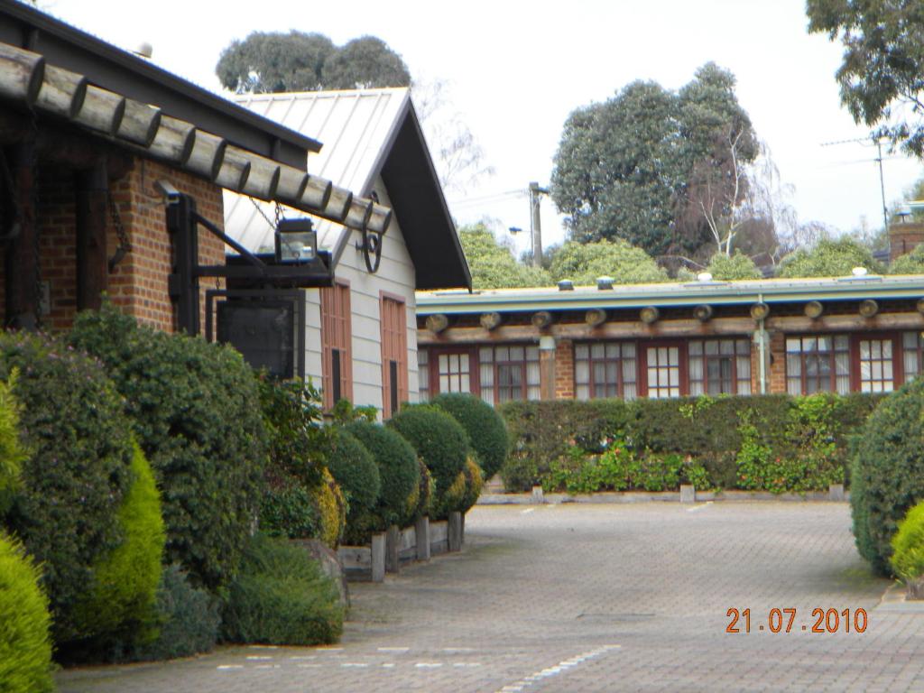 a building with a row of hedges in front of it at Mahogany Park in Cranbourne