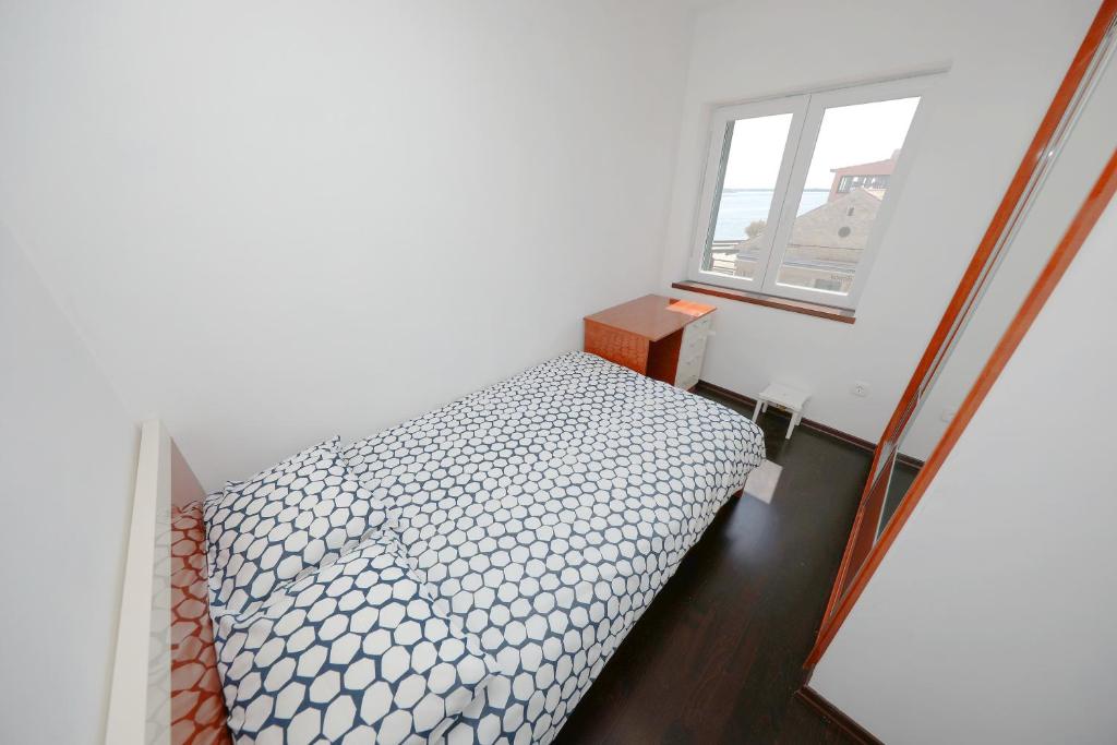 Posteľ alebo postele v izbe v ubytovaní Apartmani Postimana