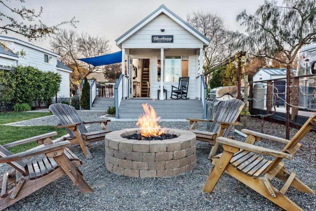 a fire pit in front of a house with chairs at Flying Flags RV Resort & Campground in Buellton