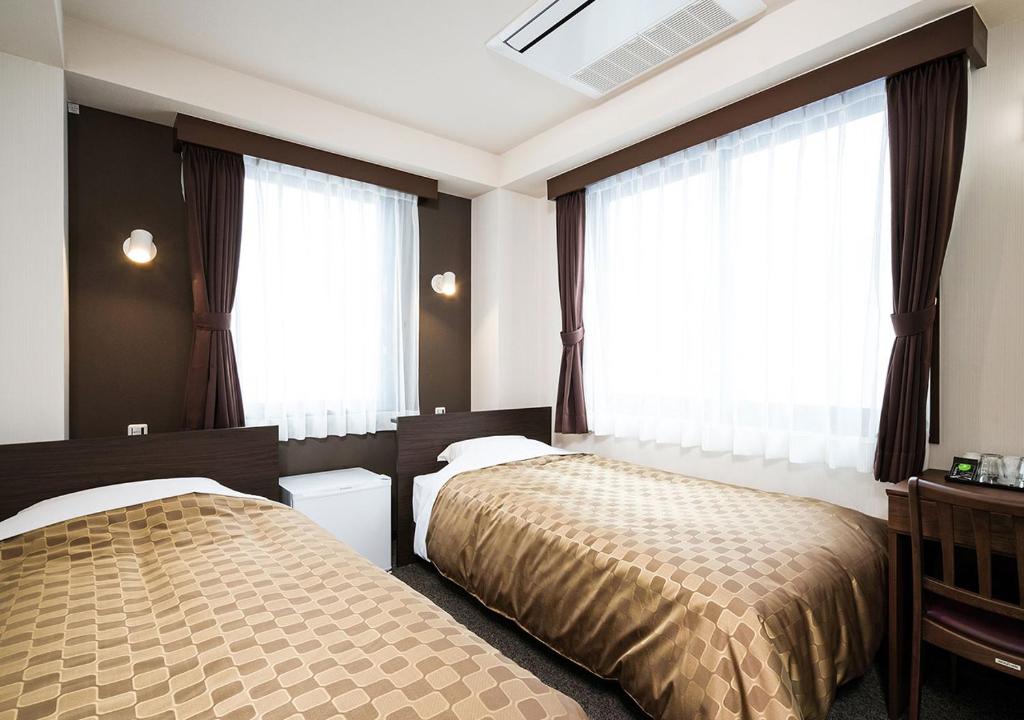 Postel nebo postele na pokoji v ubytování Hotel Trend Asakusa Annex