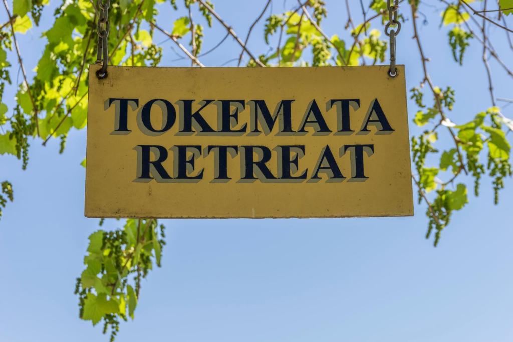 a sign that reads tozeraria retreat hanging from a tree at Tokemata Retreat in Cobram