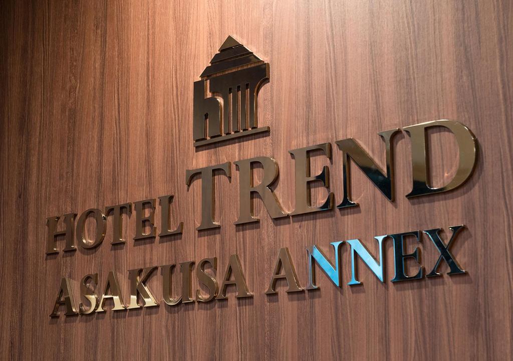 a sign on a building with a hotel akashaassurance at Hotel Trend Asakusa Annex in Tokyo