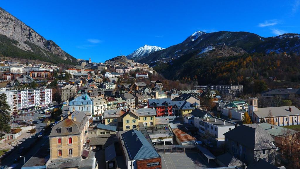 a view of a city with mountains in the background at Hôtel Mont-Brison in Briançon