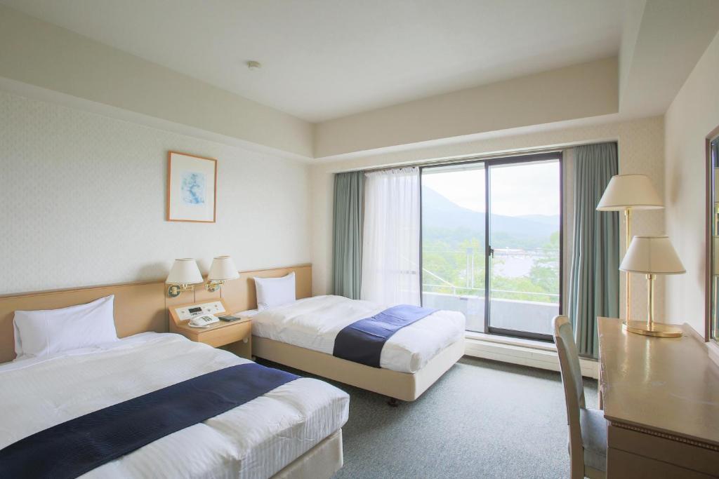 Postel nebo postele na pokoji v ubytování Izumigo AMBIENT Tateshina Hotel