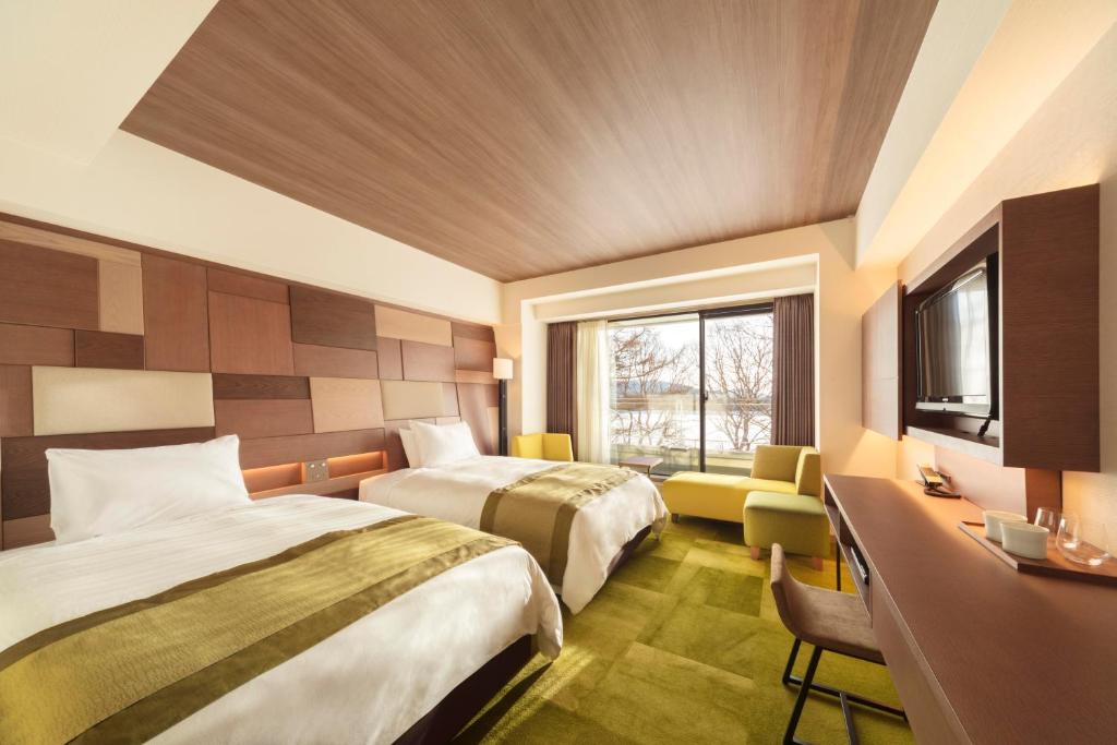 Postel nebo postele na pokoji v ubytování Izumigo AMBIENT Tateshina Hotel