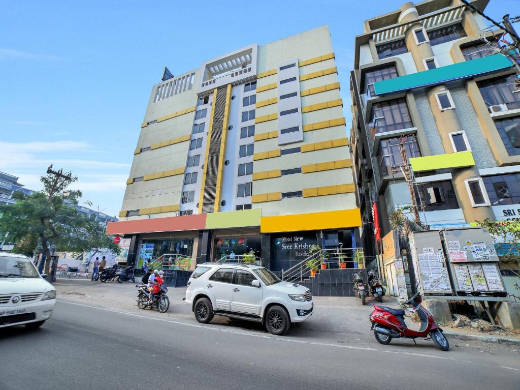 a white car parked in front of a building at Hotel New Sree Krishna Residency in Hyderabad